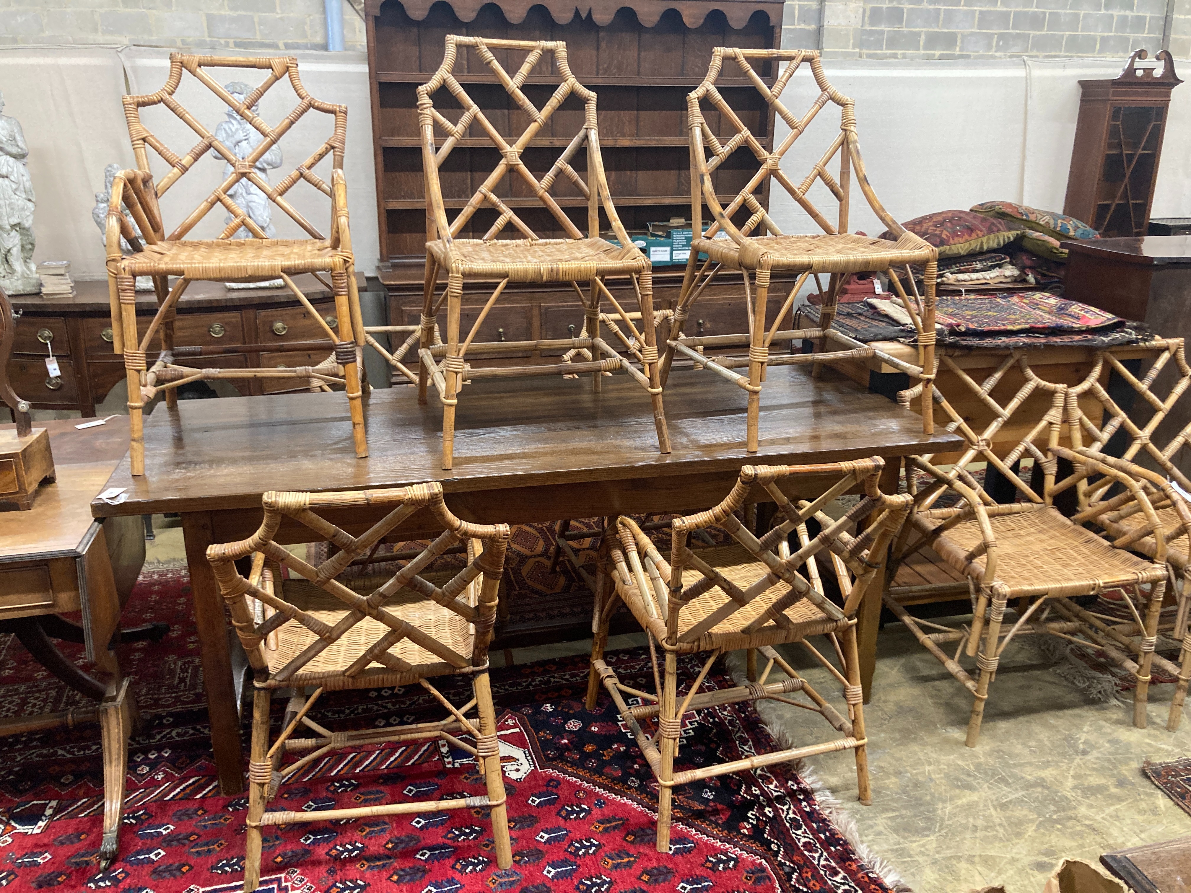 A set of nine caned bamboo chairs, five with arms